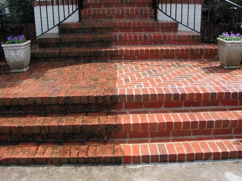Brick steps half-cleaned, showing the pressure-washing difference